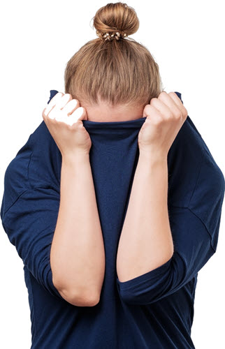 A woman pulling her sweater up over her face rather than showing how she feels.